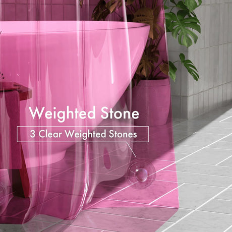 Pink bathtub with clear weighted stones on a tiled floor, surrounded by plants.