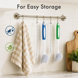 Kitchen utensils hanging on a rack with a towel against a tiled wall.