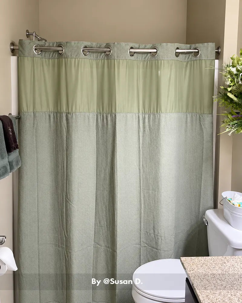 Customer bathroom photo showing a segmented shower curtain rod installed above a tub, with its joined sections visible.