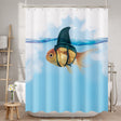 Shower curtain with a goldfish wearing a shark fin design in a bathroom setting.