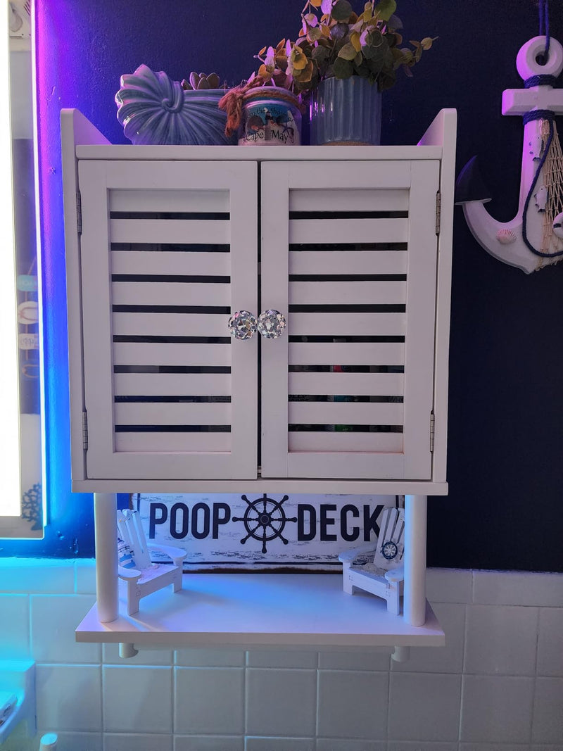 White cabinet with shutters on a tiled wall with 'POOP DECK' sign.