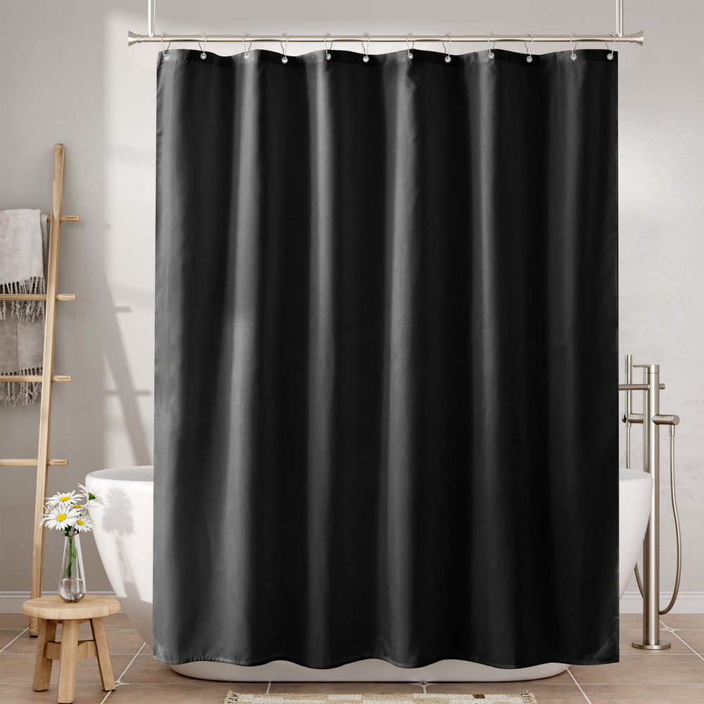 Black shower curtain in a bathroom setting with a bathtub and towel rack.