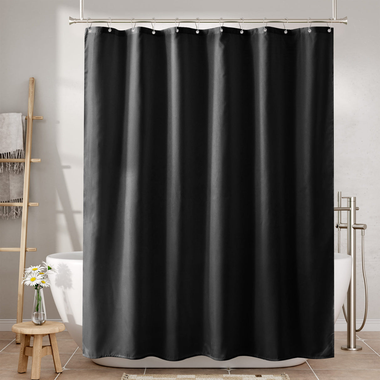 Black shower curtain in a bathroom setting with a bathtub and towel rack.
