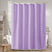 Purple shower curtain in a bathroom setting with a bathtub and towel rack.