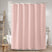 Pink shower curtain in a bathroom setting with bathtub and towel rack.
