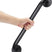 Hand holding a black grab bar against a white background