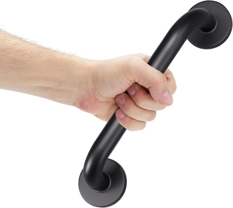 A matte black metal grab handle shown being held by a person's hand against a plain white background.