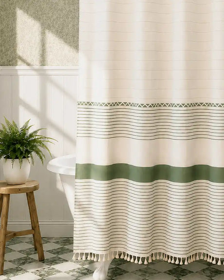 AmazerBath green botanical shower curtain with leafy print and tassel trim in a warm bathroom