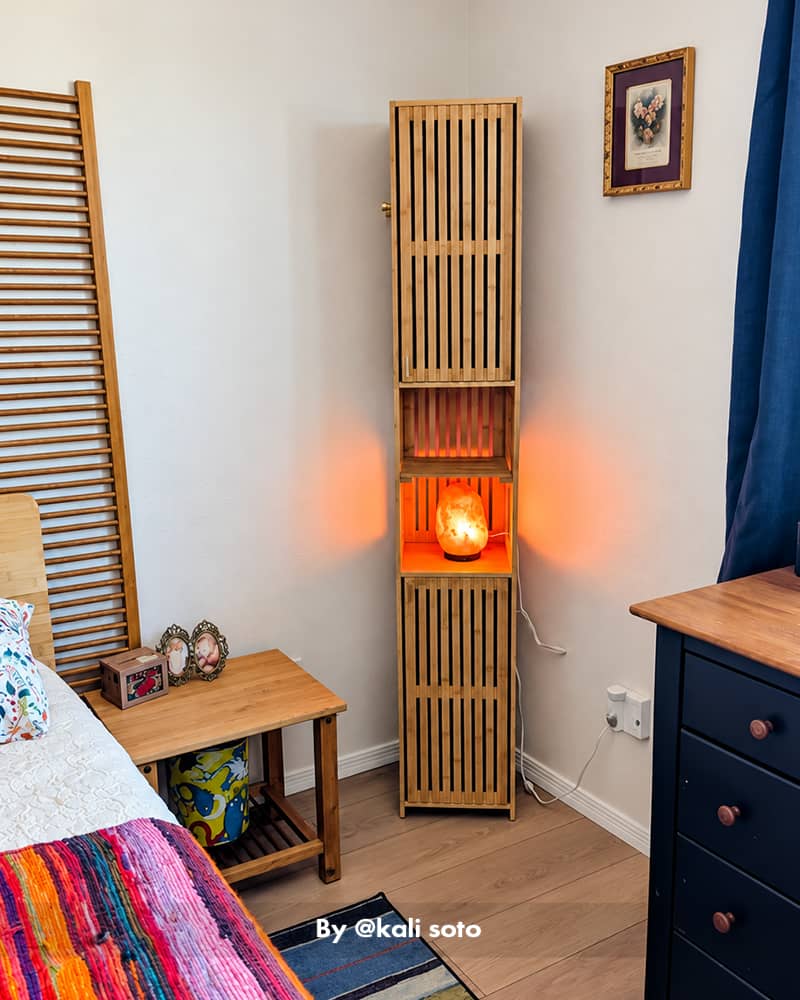 AmazerBath slim bamboo storage cabinet used as a narrow bedroom organizer with open shelves and warm accent lighting.