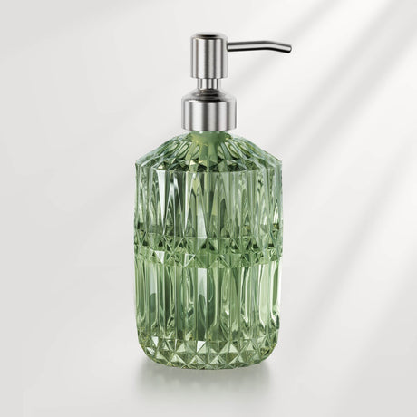 Green diamond-patterned soap dispenser with metallic pump on a light gray background