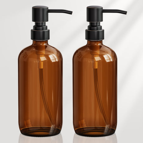 Two brown glass bottles with black pumps on a white background