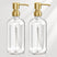 Two clear glass bottles with gold pumps on a light gray background