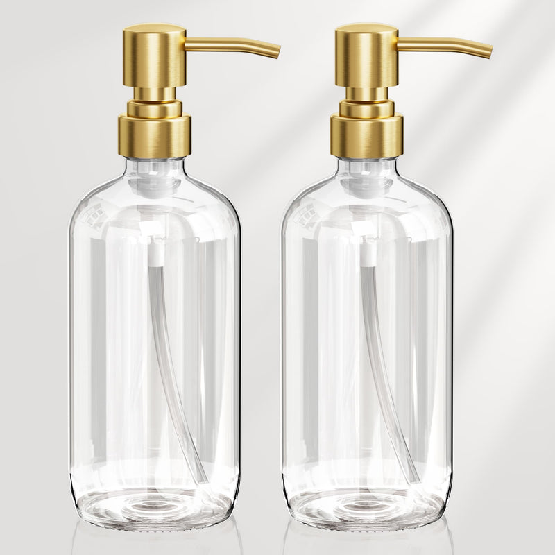 Two clear glass bottles with gold pumps on a light gray background