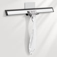Clear glass squeegee with black rubber blade on a white background