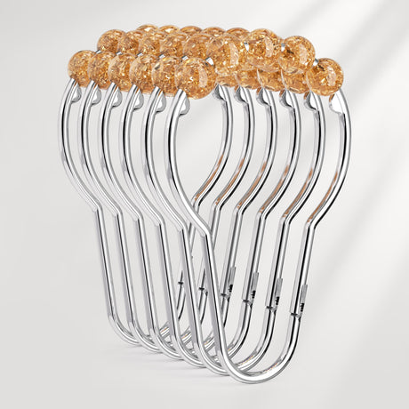 Set of clear plastic hangers with gold beads on a white background
