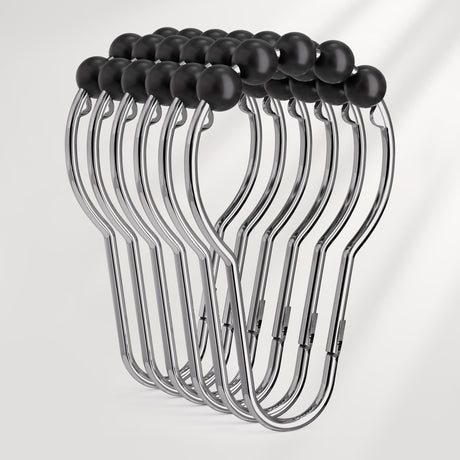 Set of metal hangers with black hooks on a white background
