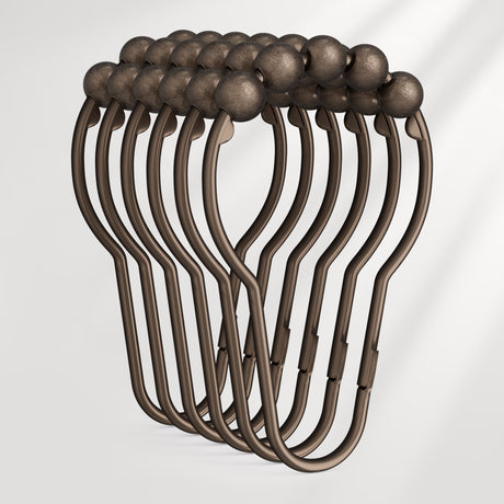 Set of bronze-colored hangers on a white background