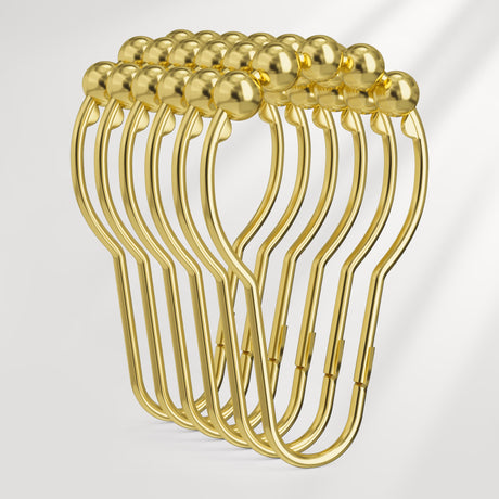 Set of gold metal hangers on a light gray background