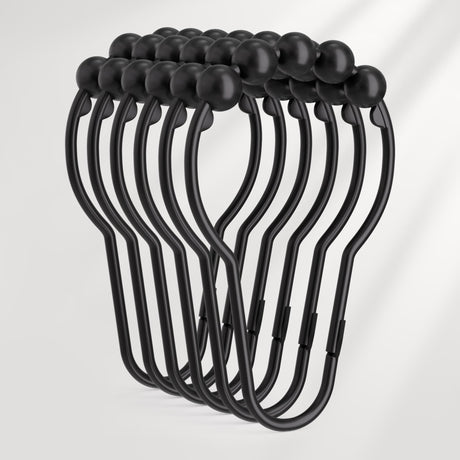 Set of black metal hooks on a light gray background