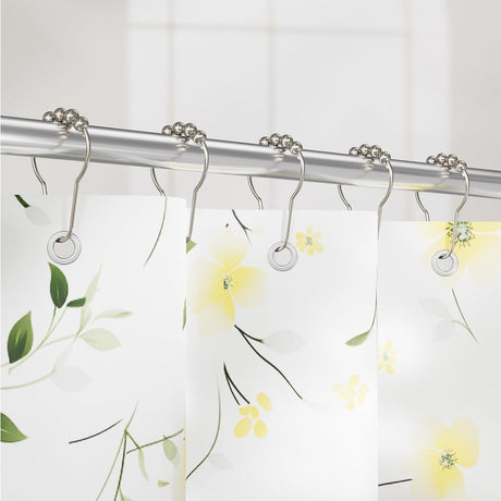 Shower curtain with floral design and metal shower hooks on a white background