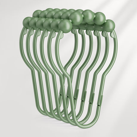 Set of green hangers with round knobs on a white background