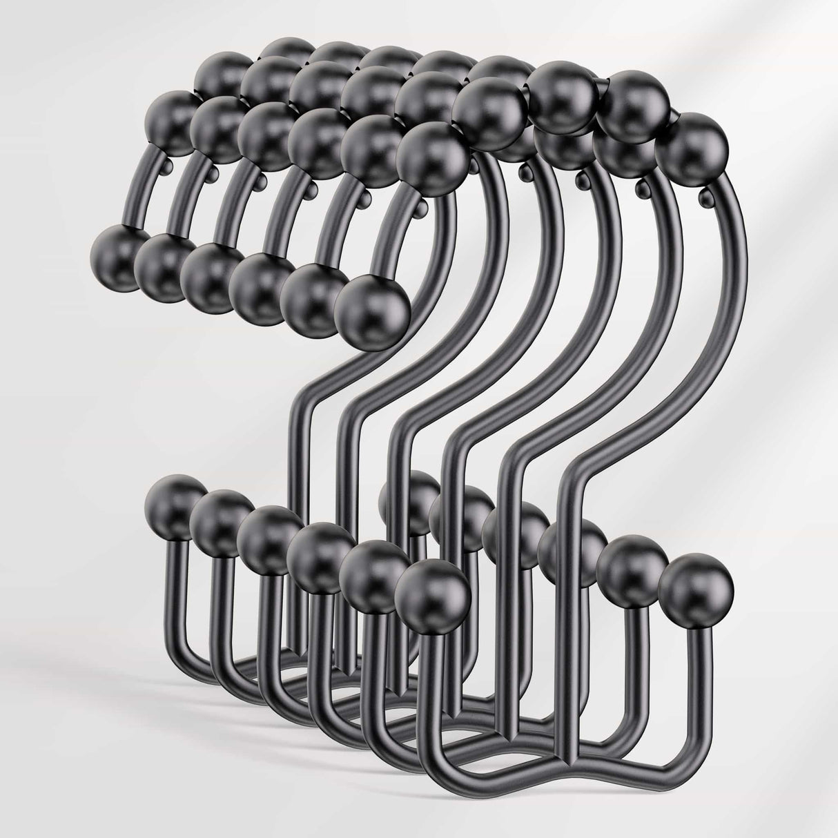 Set of black metal hooks on a white background