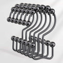 Set of black metal hooks on a white background