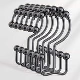 Set of black metal hooks on a white background