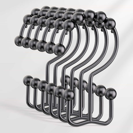 Set of black metal hooks on a white background