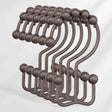 Set of metal hooks with spherical ends on a white background