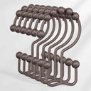 Set of metal hooks with spherical ends on a white background