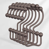 Set of metal hooks with spherical ends on a white background
