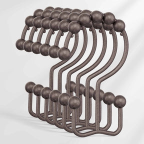 Set of metal hooks with spherical ends on a white background