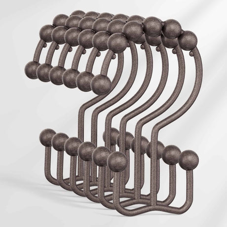 Set of metal hooks with spherical ends on a white background