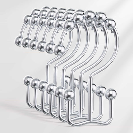 Set of metal hangers with spherical ends on a white background