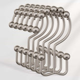 Set of metal hooks with spherical ends on a light gray background
