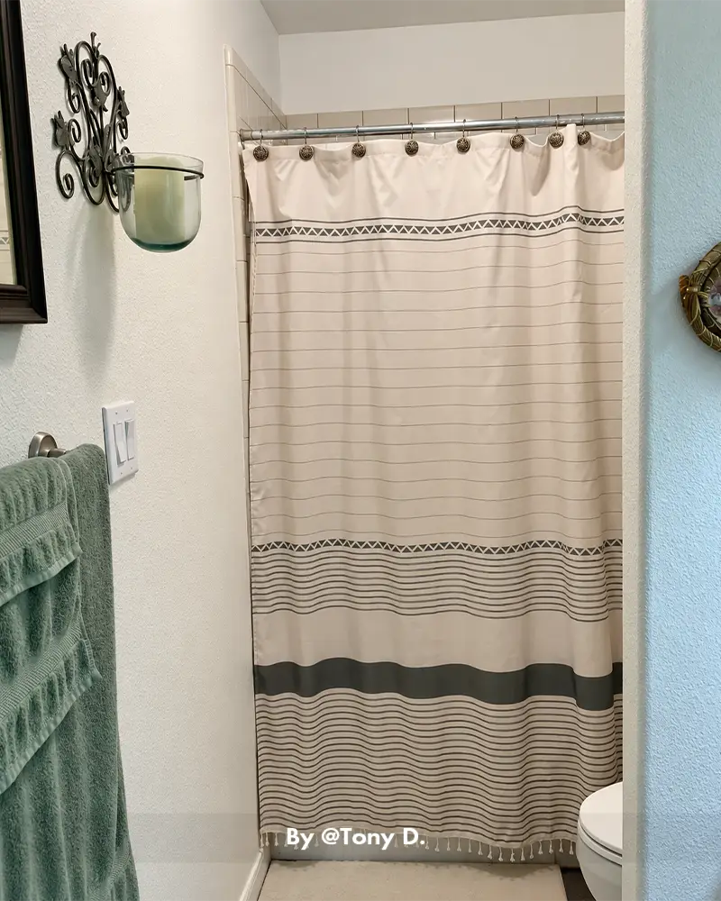 AmazerBath boho striped shower curtain hanging over a bathtub, featuring woven texture in a casual customer bathroom