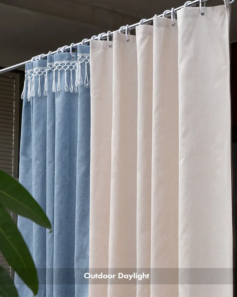 AmazerBath blue and white top tassel shower curtains in outdoor daylight showing fabric texture and fringe.
