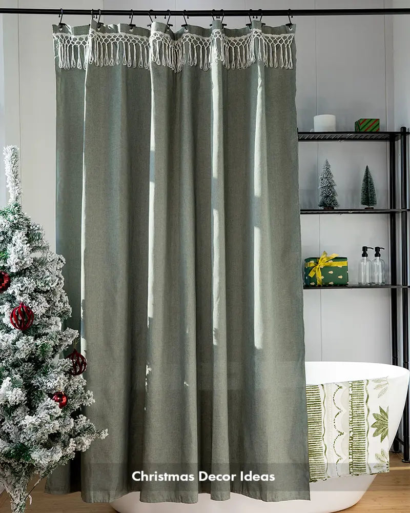 AmazerBath green top tassel shower curtain styled for Christmas beside a decorated tree and white bathtub.