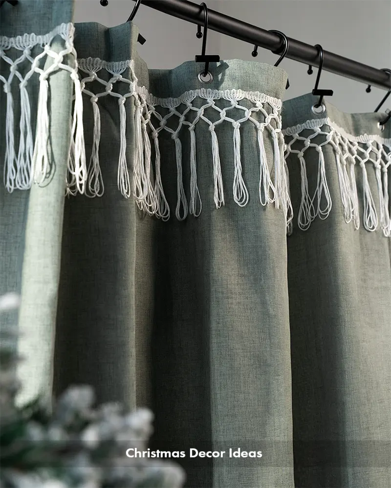 AmazerBath green top tassel shower curtain close-up showing textured fabric, metal hooks, and knotted fringe.