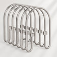 Metallic shower curtain hooks on a white background