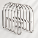 Metallic shower curtain hooks on a white background
