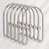 Metallic shower curtain hooks on a white background