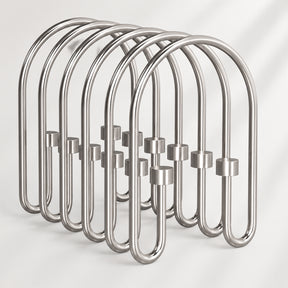 Metallic shower curtain hooks on a white background