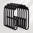Black metal hooks arranged in a circular pattern on a white background