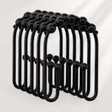 Black metal hooks arranged in a circular pattern on a white background