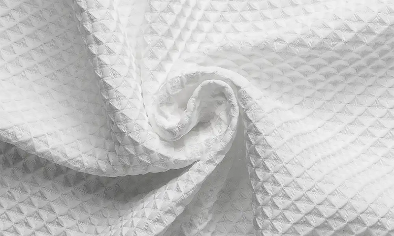 AmazerBath white waffle shower curtain fabric shown in a soft textured close-up