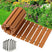 Wooden deck tiles with installation hardware on a garden background