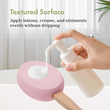 AmazerBath pink back lotion applicator used to apply lotion to the upper back.