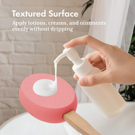 Lotion dispensed onto the textured blush pink EVA pad of the AmazerBath back applicator.